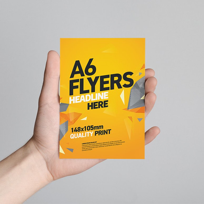 A6 Flyer / Postcard / Invitation Mock-Up - Male hands holding a blank flyer on a gray background.